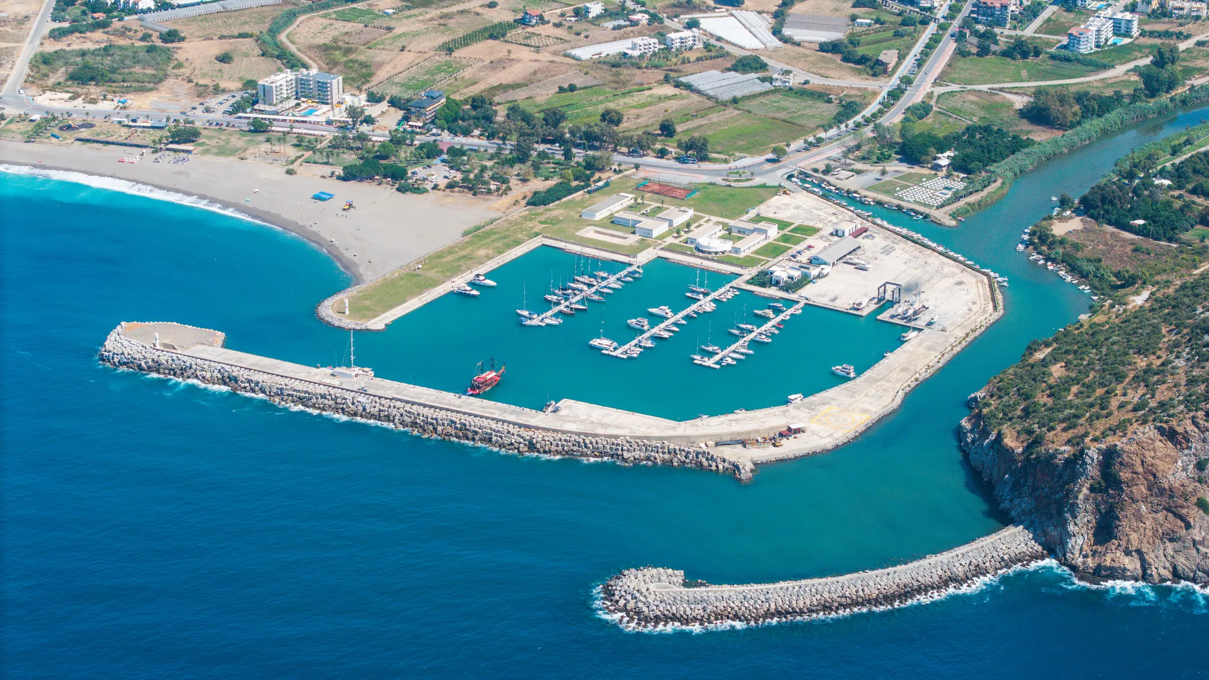 Aerial view of Gazipaşa Gold Marina with its breakwaters, mooring basin and coastline